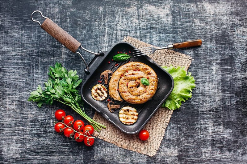 Homemade tasty spiral grilled sausage with healthy vegetable pan