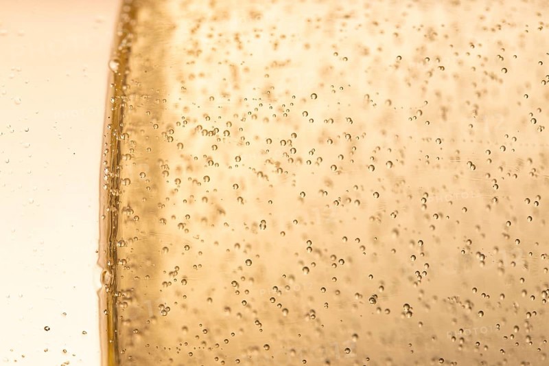 Side view glass with champagne bubbles