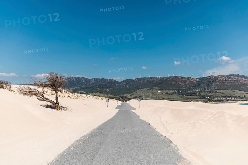 Empty road sands against mountains