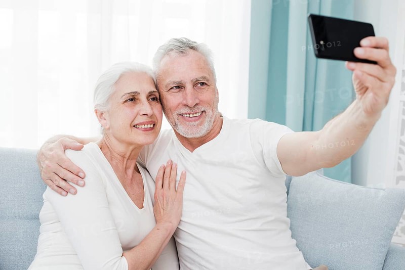 Elder couple making selfie