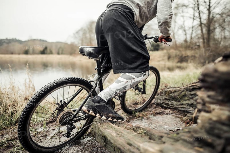 Cyclist riding bike near lake