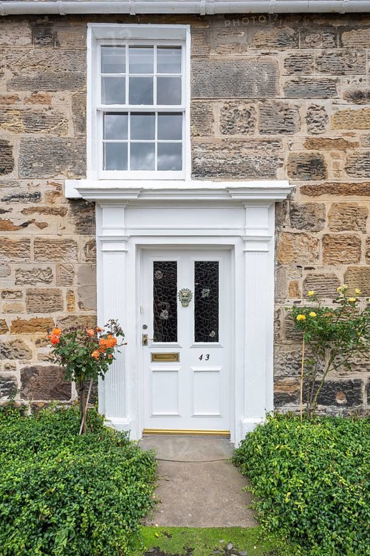 White front door on an old stone house