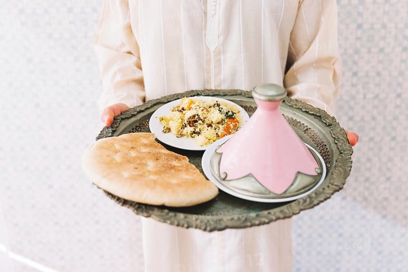 Muslim man holding plate food