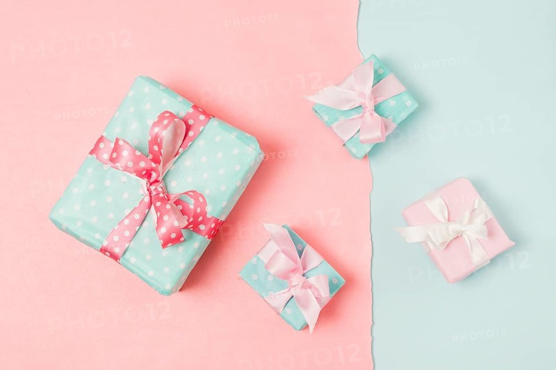 Small big decorated gift boxed tied with ribbon arrange peach blue wallpaper