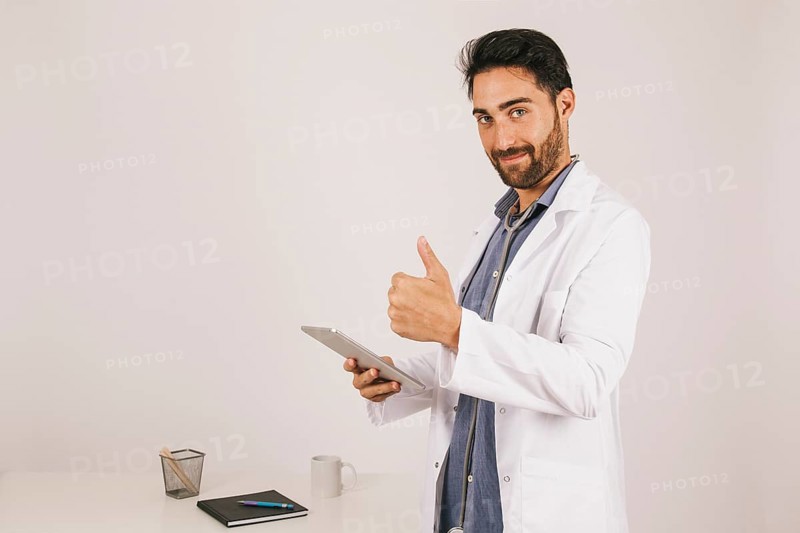 Doctor with ipad thumb up