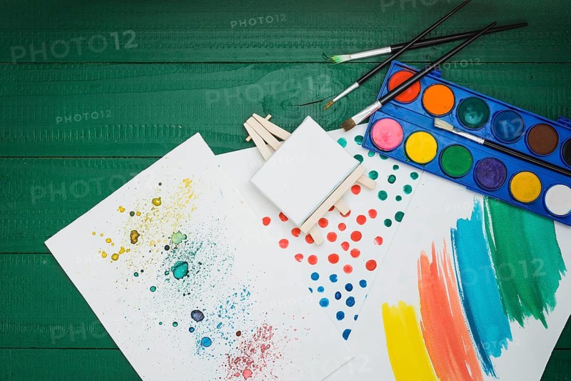 Watercolor stained brushstroke white sheet with mini easel watercolor palette