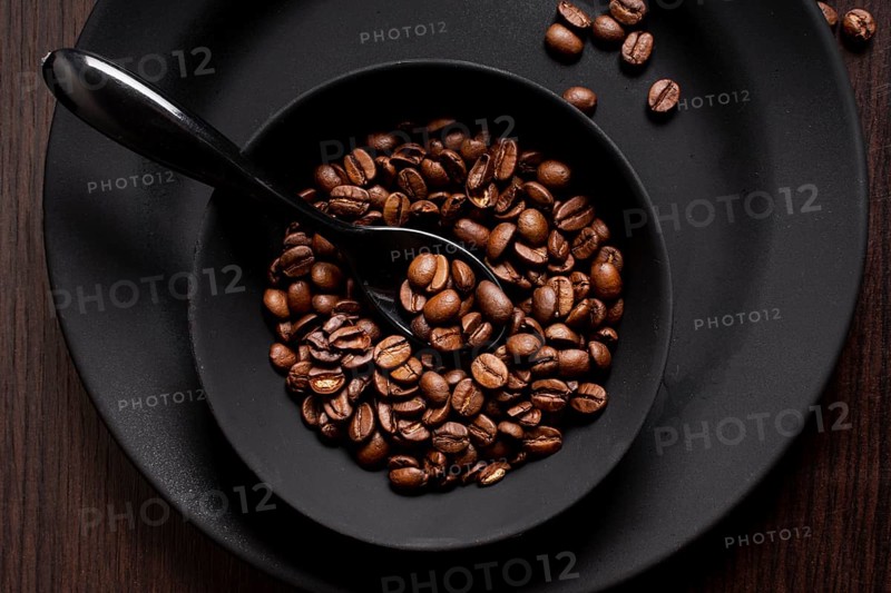 Roasted coffee beans bowl with spoon