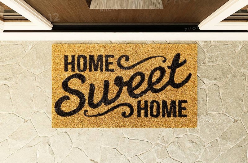 Home sweet home doormat on the porch at the front door