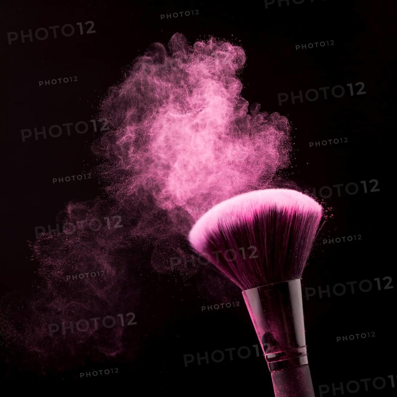 Bright dust powder brush makeup black background