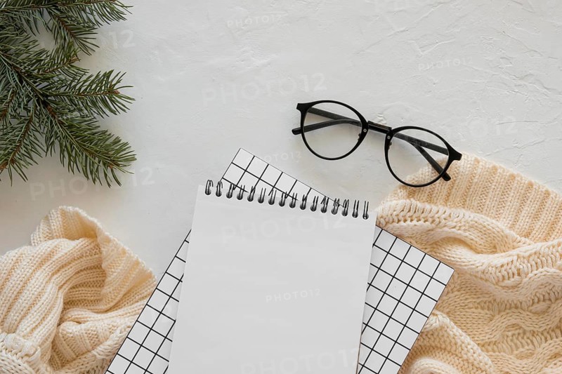 Top view stationery empty papers with reading glasses