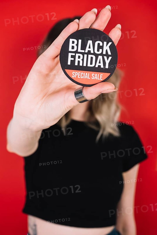 Close up woman hand with black friday sign