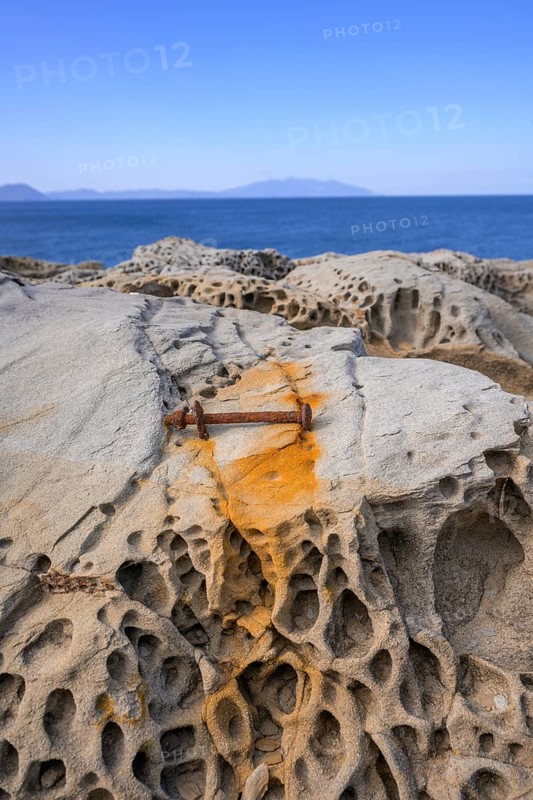 Rusty screw and stone structures in the Buca delle Fate