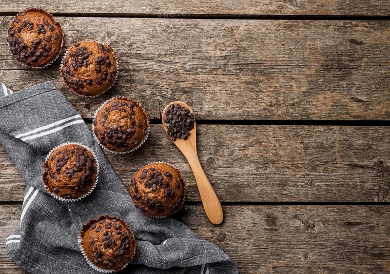 Top view delicious arrangement muffins wooden background