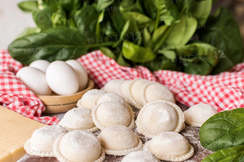 Circular raw ravioli with spinach eggs