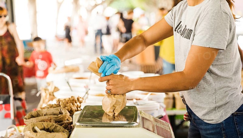 Woman seller packing food her customer market