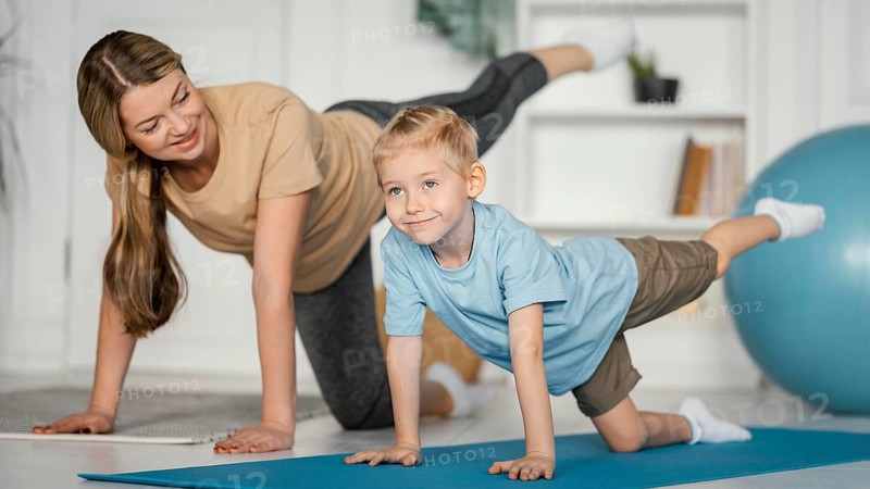 Full shot woman kid exercising together