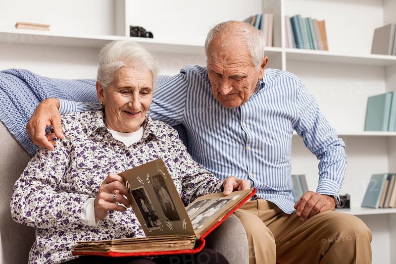 Mature couple looking into album