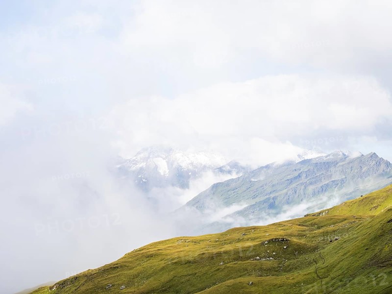 Morning fog drifts over a mountain ridge