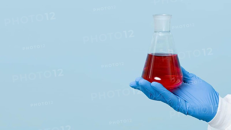 Front view scientist holding red chemical with copy space