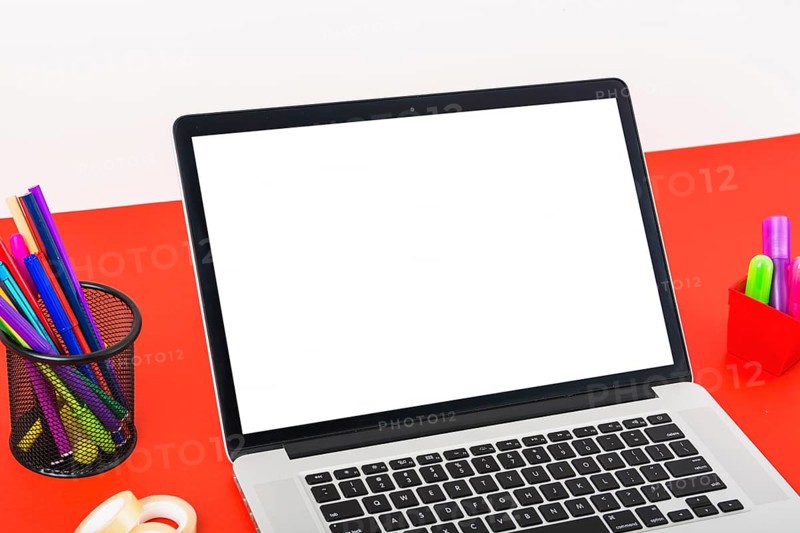 Close up modern laptop with blank white screen red table