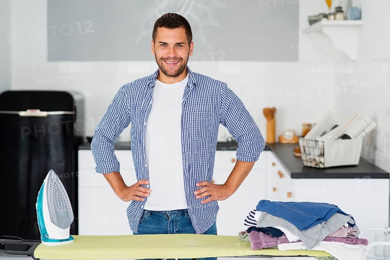 Male home preparing iron clothes