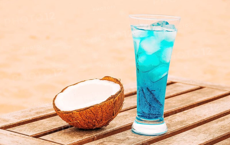 Cracked coconut glass bright blue drink wooden table