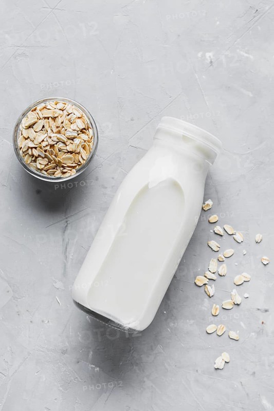 Flat lay milk bottle with oats