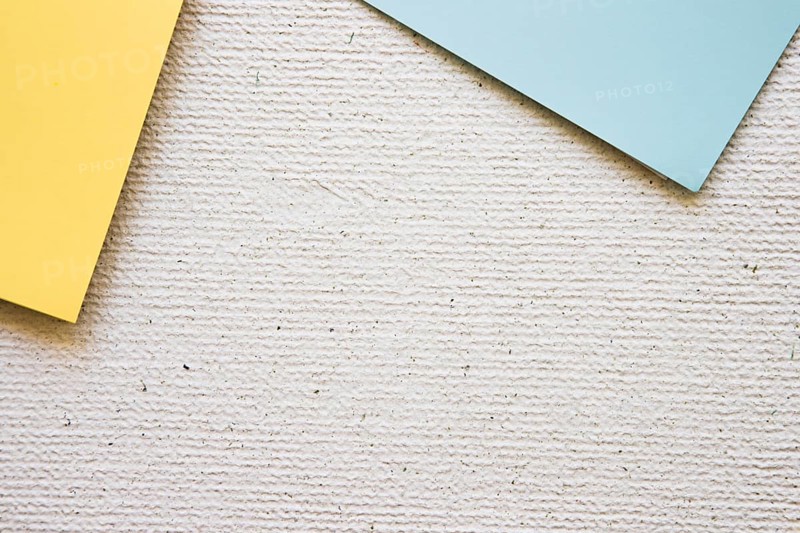 Overhead view grey yellow cardboard papers concrete background