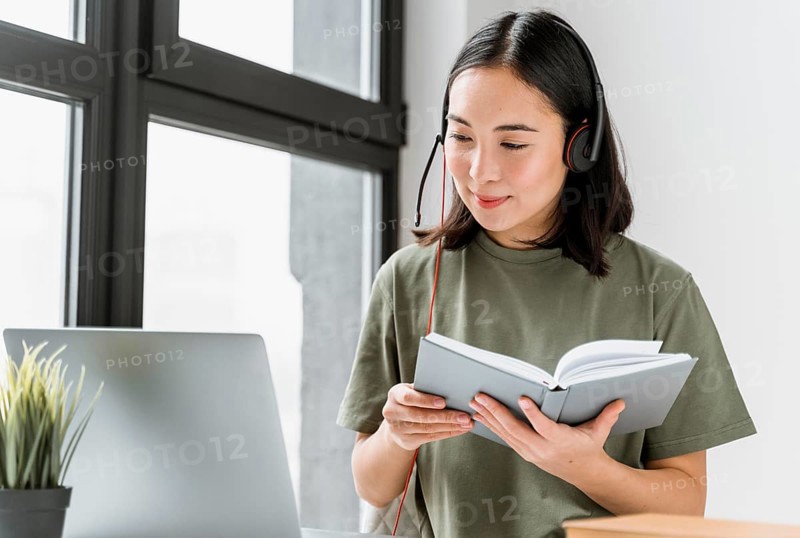 Woman with headset having video call laptop_3