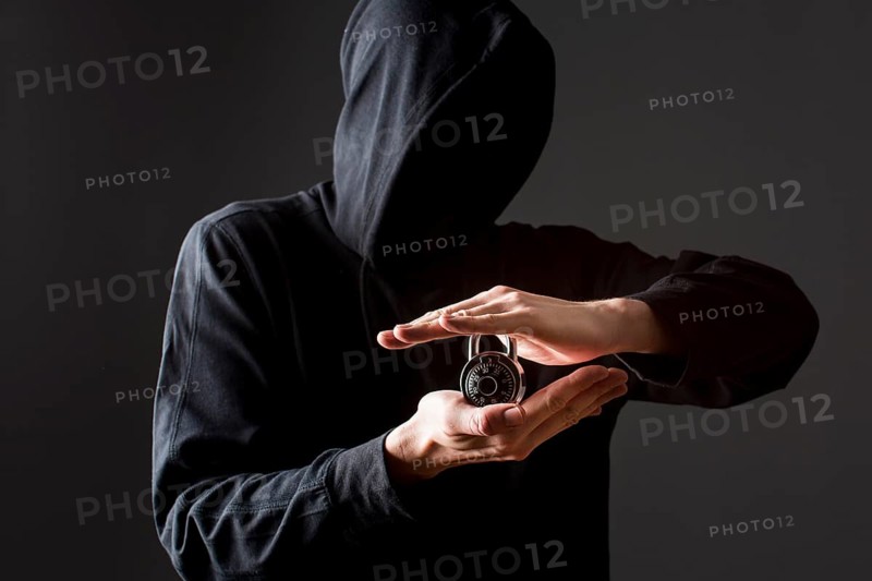Front view hacker holding lock