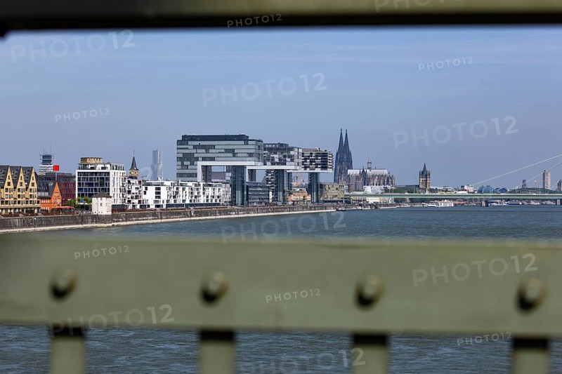 View of the city of Cologne and the Rhine through the railing of the South Bridge with Rheinauhafen