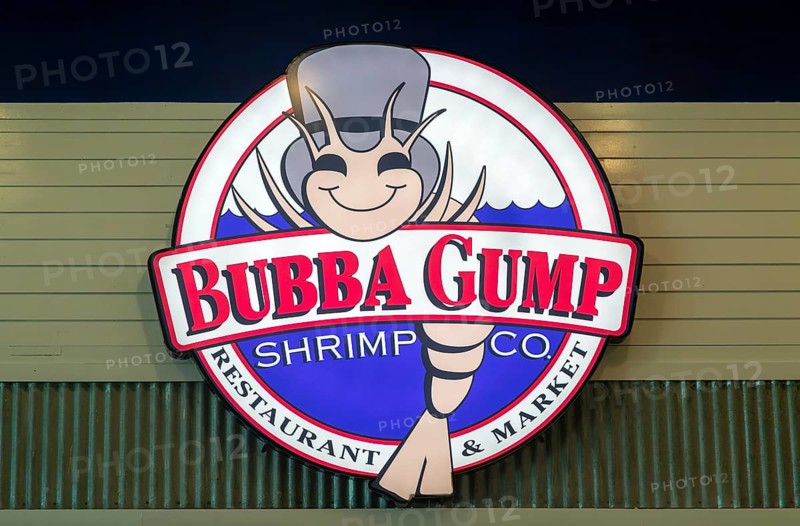 Electronic sign for Bubba Gump shrimp restaurant inside Cancun airport