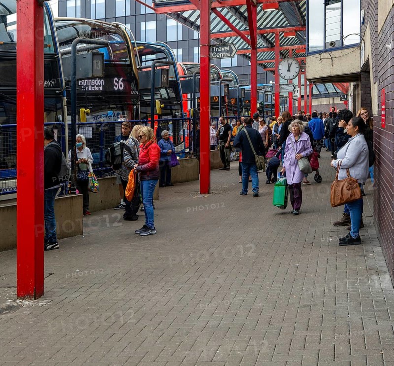 People and buses in bus station in the town centre