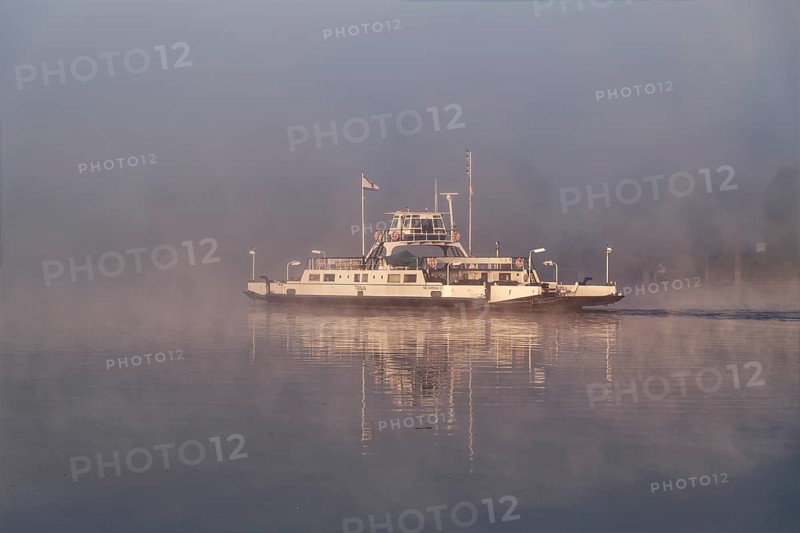 The Elbe ferry Tanja in the early morning mist between Darchau and Neudarchau on the Elbe in the UNESCO Biosphere Reserve Elbe River Landscape. Amt Neuhaus