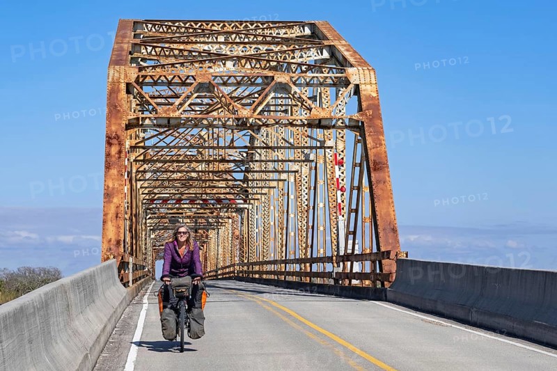 Cyclist and 1929 Chef Menteur Pass Bridge between New Orleans and Slidell on eastern side of Lake Pontchartrain