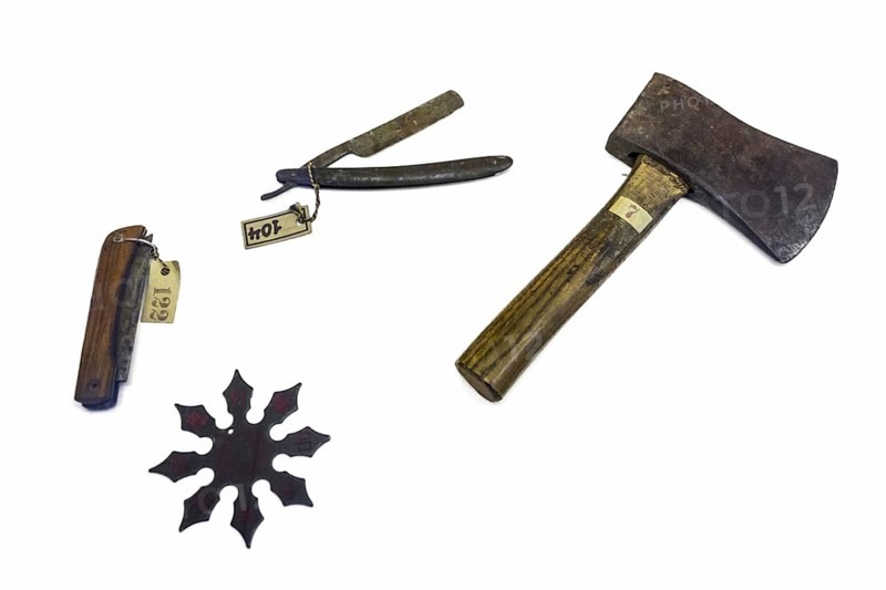 Old murder weapons against white background: pocket knife