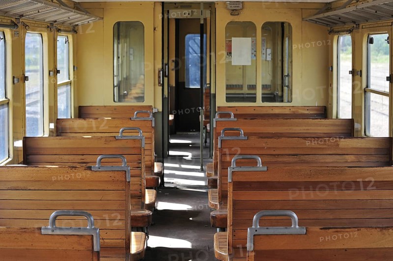 Old passenger carriage with wooden benches at the depot of the Chemin de Fer a Vapeur des Trois Vallees at Mariembourg