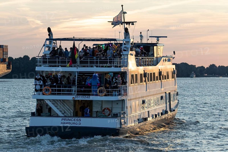 Party guests on the excursion ship MS Princess at dusk underway on the Elbe in Hamburg harbour