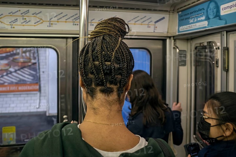 Woman with braided pigtails in the metro