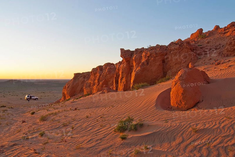 Landcruiser in the last evening light in front of the Flaming Cliffs
