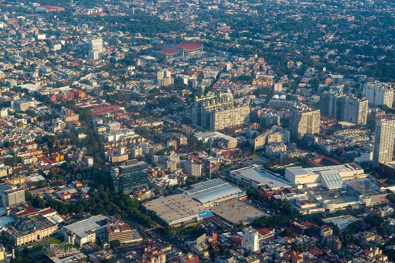 Oblique angle aerial view through plane window over Universidad district