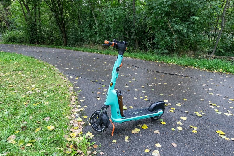 E-scooter of bike rental company TIER parked on pavement