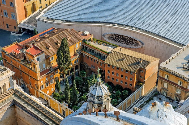 Bird's eye view of German cemetery in the Vatican next to St. Peter's Basilica in the background next to it roof of audience hall for audience with Pope