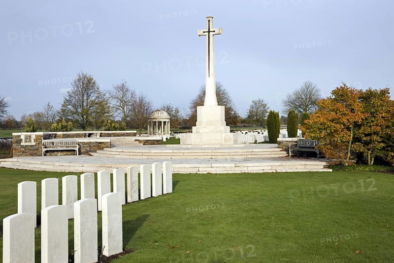 Cross of Sacrifice at the Bedford House cemetery with graves of First World War British Empire soldiers at Zillebeke near Ypres