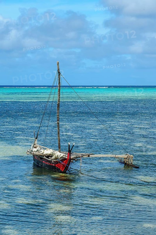 Traditionesses Dugout Canoe Dugout canoe lies in turquoise blue lagoon of Yap Island in Pacific Still Ocean