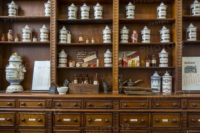 Antique pharmacy cabinet with vintage porcelain jars in the Hopital Notre-Dame a la Rose