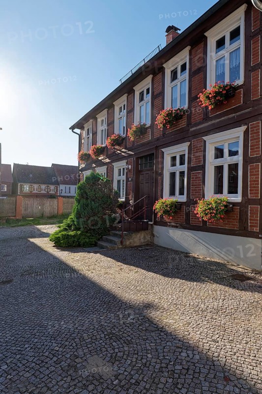 Half-timbered house decorated with flower boxes in the cobbled Lange Strasse in the Hanseatic town of Werben in the Altmark region. Werben