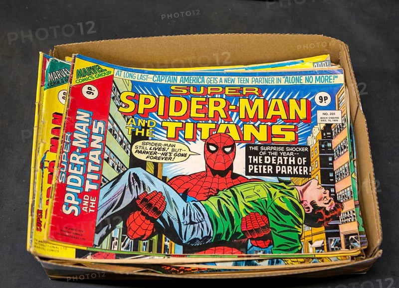 Box of Super Spider-Man Titans comics on display in auction room