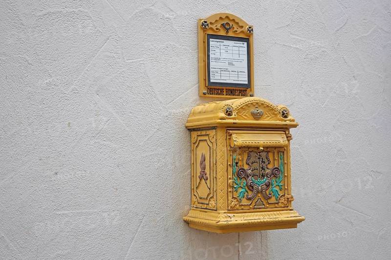 Historical yellow mailbox with ornaments