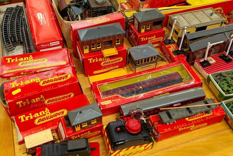 Boxes of vintage Tri-ang Railways scale model toy train set on display in auction room